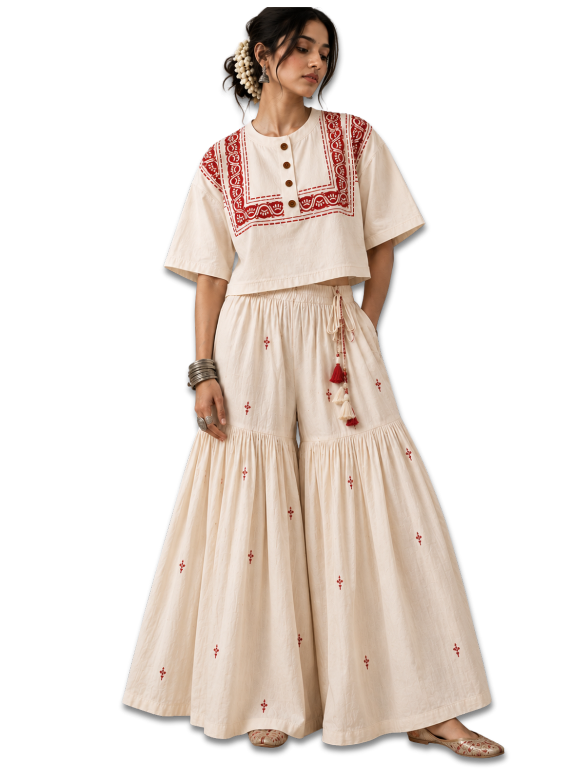 Karigari women's cream crop top worn with cream printed wide-leg pants, showing red paisley border detailing and four wooden buttons.