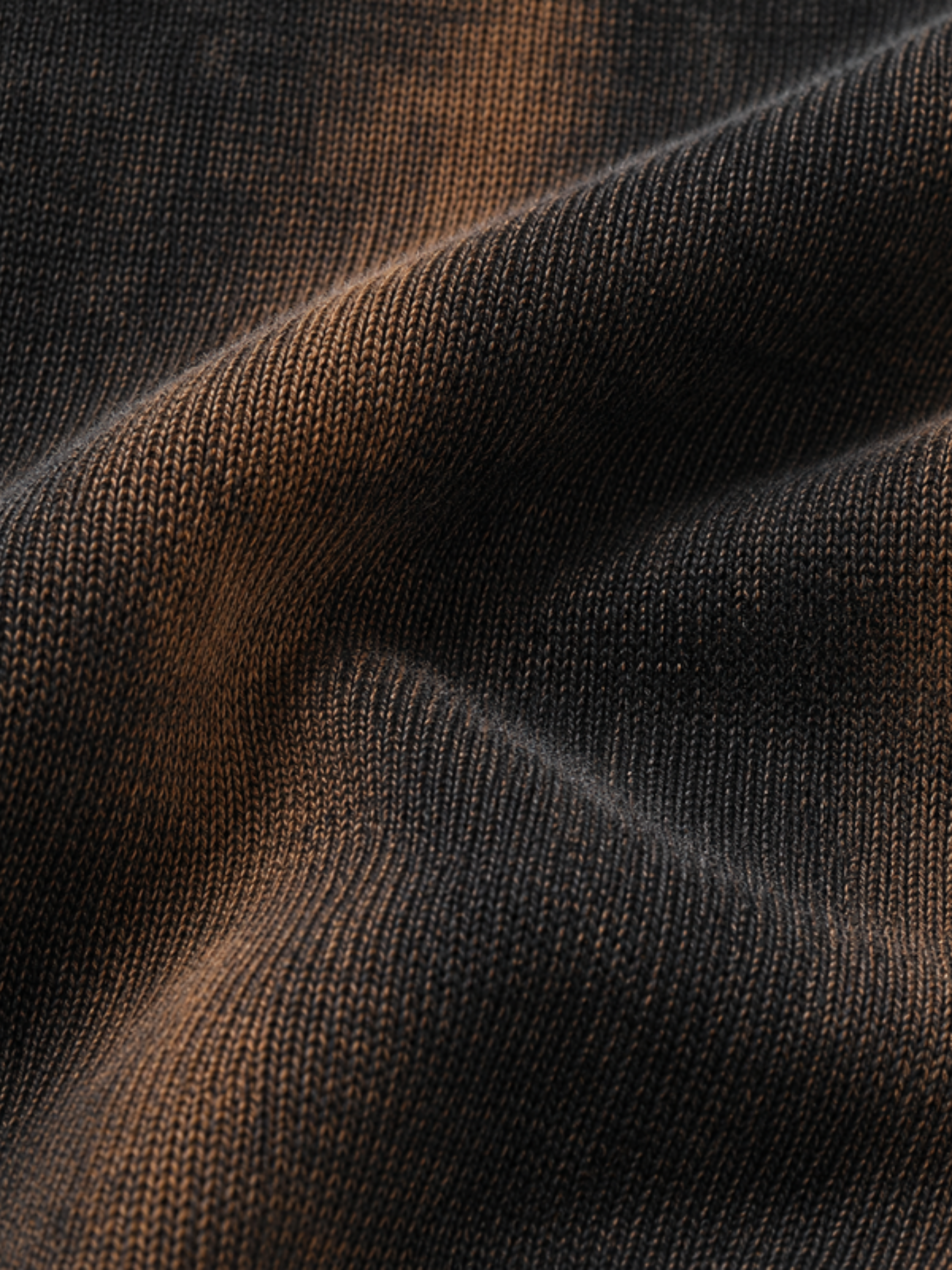 Rust streaked black oversized crop top close-up — Atached rust-wash print detail for women